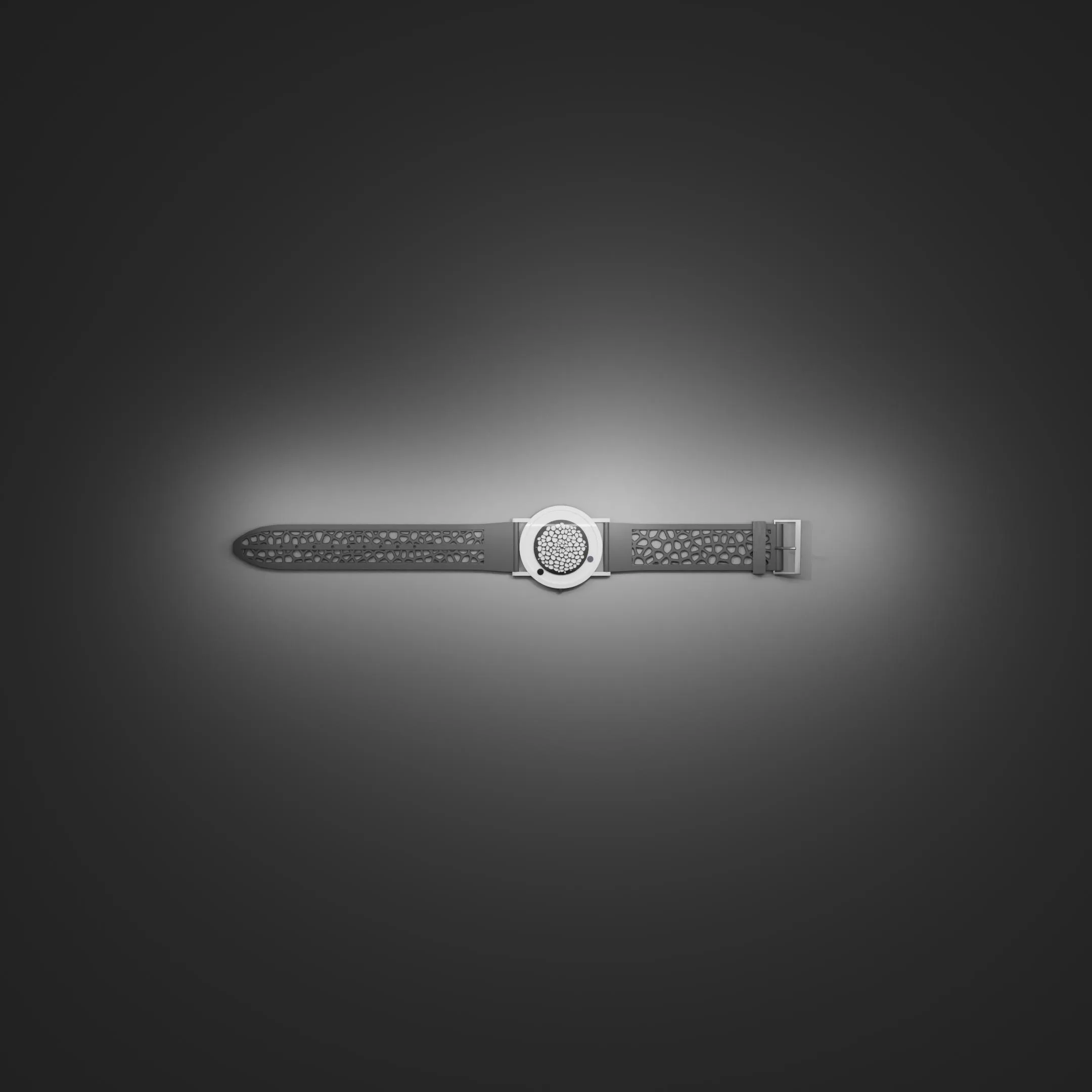 Descartes watch lying on a dark surface under a soft spotlight
