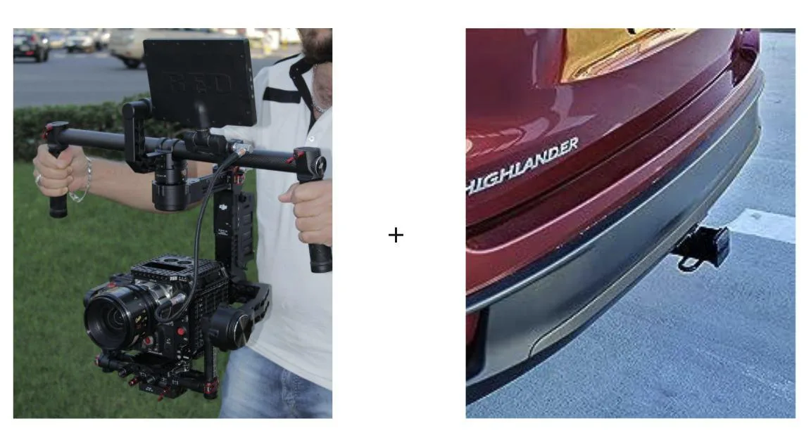 A handheld camera gimbal next to a tow hitch on the back of an SUV