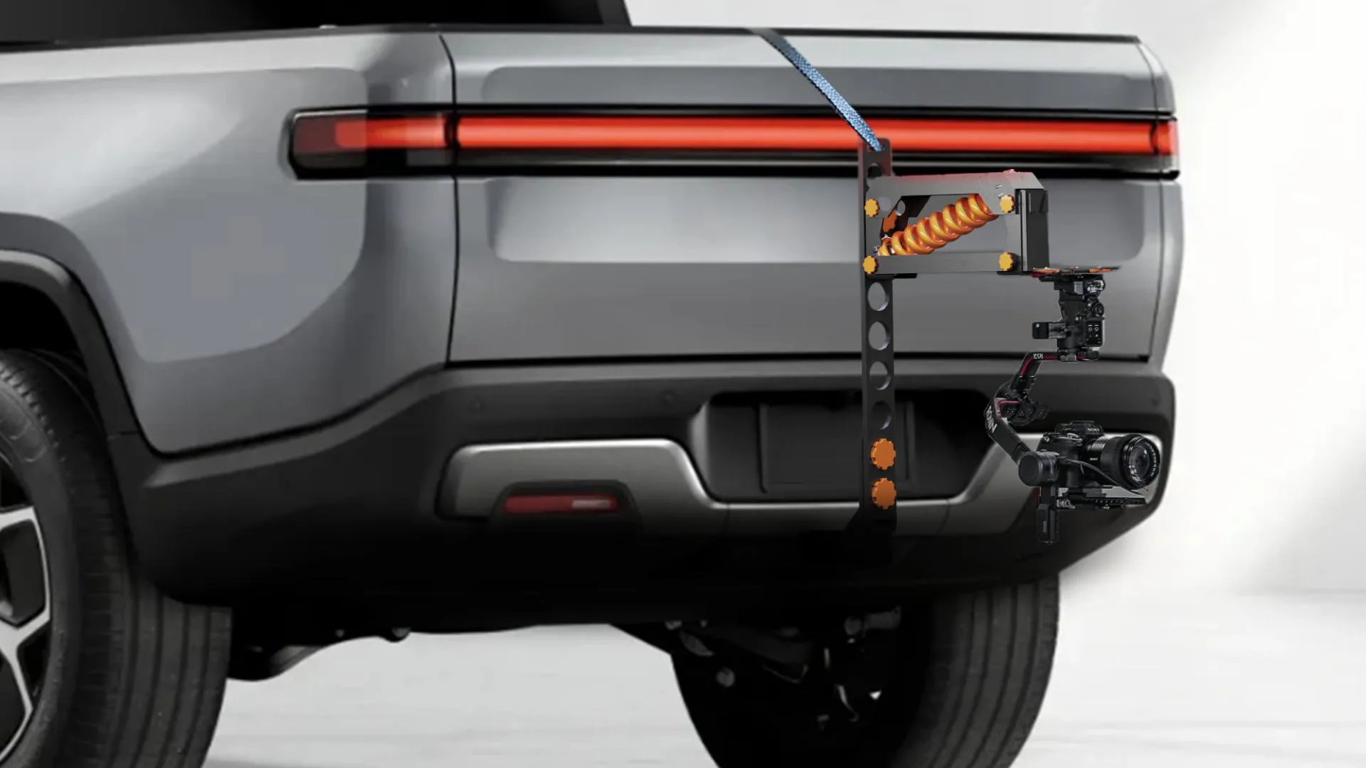 STATO mounted on the back of a pickup truck with a strap securing the camera